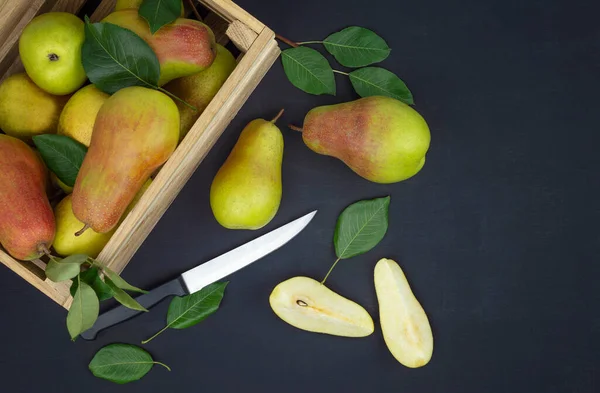 Autumn background. Ripe pears with leaves in a wooden box. Top view. Flat lay.Fresh organic pears. Fruit background. Pear autumn harvest.fresh good delicious pears