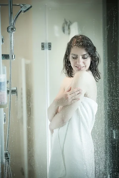 Relief and relaxation after long stressful day.Taking moment for yourself concept.Skincare,spa and aromatherapy.Unfocused portrait of a woman showering through the bath screen with little drops — 스톡 사진