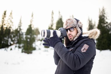 Profesyonel fotoğraf makinesi dağ fotoğraf çekimi olan adam. Bir dağ manzarası fotoğraf çekici. Fotoğraf makinesi ve telefoto lens fiyatı