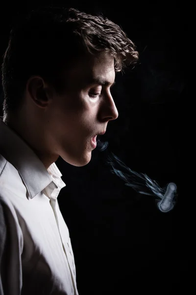 Cigarette addiction.Tobacco nicotine smoke. Unhealthy,danger,bad,narcotic habit.Health risk,cancer illness.Young man adolescent smoking tobacco cigarette.Nicotine addiction.Smoke ring.Vice — Stockfoto