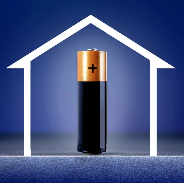 Battery of energy and sketch of home against blue background. Home energy concept.