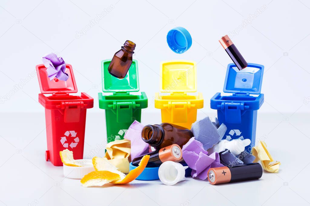 Waste sorting recycling concept.  Toy garbage containers for separate waste collection. 