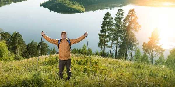 Happy Man Traveler With Backpack Hiking In Mountains. Freedom concept. Banner.