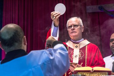Sao Paulo, SP, Brazil, April 19, 2016. Mass celebrated by Cardinal Archbishop of Sao Paulo Dom Odilo Sherer during the Holy Day Expedito in Santo Expedito church, in the neighborhood of Light in Sao Paulo. clipart