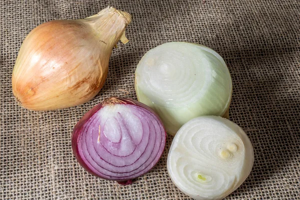 Red, yellow and white onions on white background in Brazil