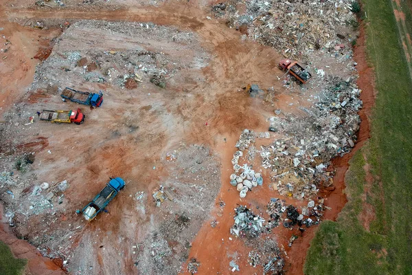 Aerial view made by drone of trucks unloading debris at the Landfill in Brazil