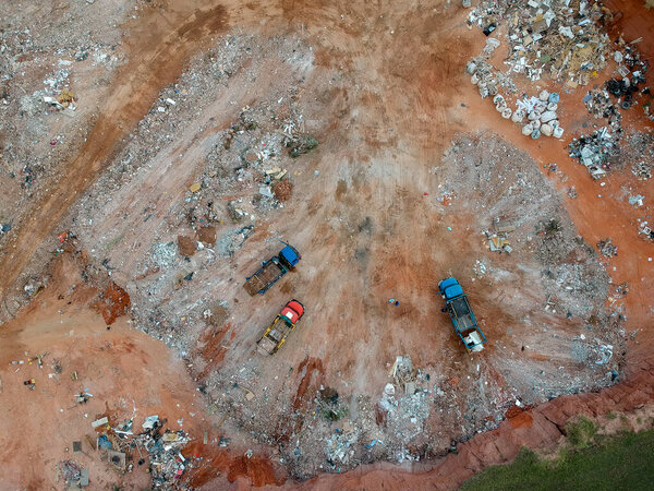 Aerial view made by drone of trucks unloading debris at the Landfill in Brazil