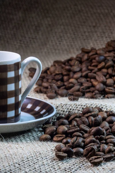 cup of coffee and grain coffee beans on jute background in Brazil