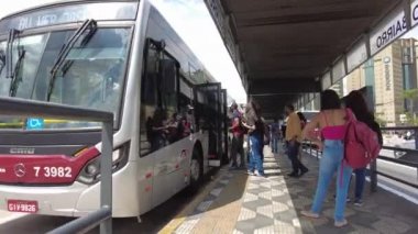 Sao Paulo, Brazil, January 12, 2021. Movement of passengers and vehicles in parada de onibus on bus corridor in Ibirapuera Avenue, south side of Sao Paulo