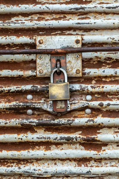 Old padlock on rusty iron door. Old rusty key lock steel door in Brazil