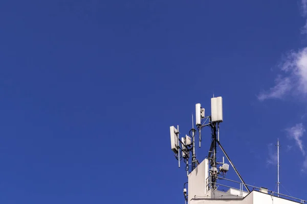 Telecommunication tower with copy space in roof top of building.Digital wireless connection system.Development of communication systems in urban areas.