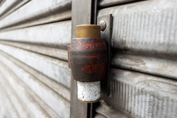 Lock on a steel door of a store on street in Brazil