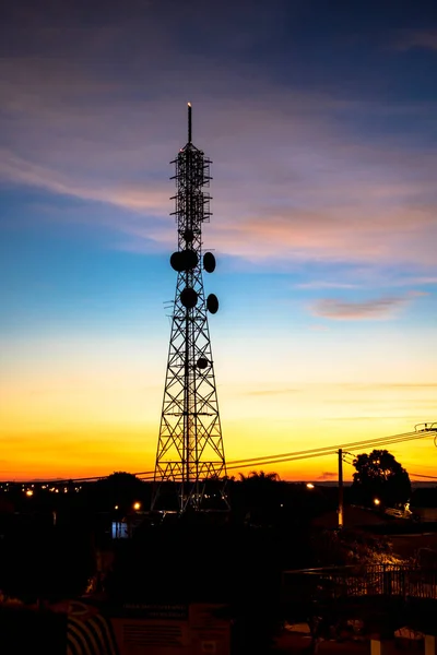 Silhouette of a telecommunications antenna in Brazil during a sunset