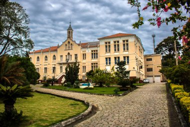 Amparo, SP, Brezilya, 21 Mart 2022. Amparo, SP, Brezilya 'da Colegio Nossa do Amparo' nun tarihi binası. Dramatik bir gökyüzü altında klasik mimari ve güzel bahçelerin yer aldığı bir yer..