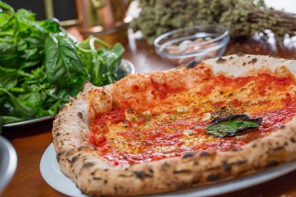 Traditional italian pizza with tomato sauce, garlic and basil, o