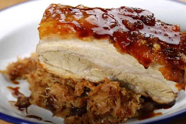 Roast pork belly with sweet apricot jam and sour cooked cabbage on a metal plate — Stock Photo, Image