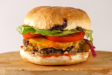 Lezzetli peynir sığır eti burger marul, çedar, Barbekü sos, marul, çedar, barbekü sosu, domates, turşu ve cacık ile lezzetli peynir sığır eti burger