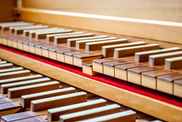 Harpsichord keyboard close-up view with a playing tone