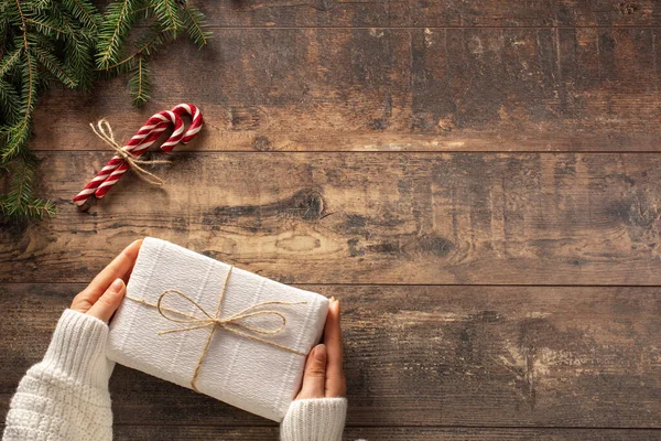 Christmas Present Gift Box Woman Hands Wooden Rustic Background Branches — Stock Photo, Image