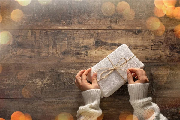 Woman Hands Unpacking Gift Box Rustic Wooden Table Holiday Bokeh — Stock Photo, Image