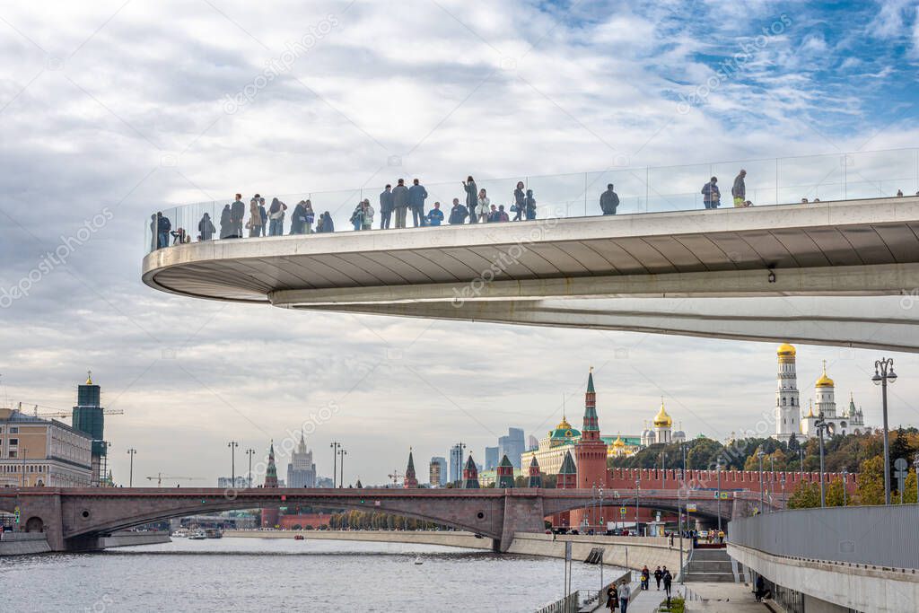 The floating bridge with people above Moscow river in the park Zaryadye near Red Square. Landscape architecture of Moscow