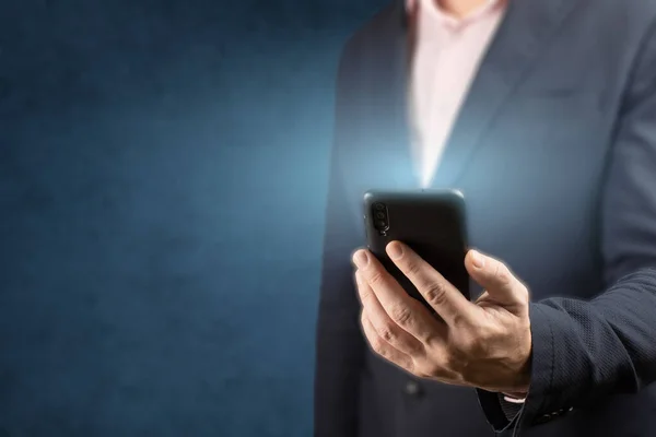 ビジネスマンは携帯電話を持っている 男は手に携帯電話を持っている彼に向かって輝く画面で ビジネスオンラインの概念です 青の背景 コピースペース — ストック写真