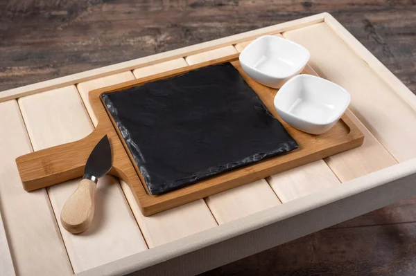 empty cheese serving Board on wooden rustic background. empty wooden tray for breakfast. board for filing sushi or cheese