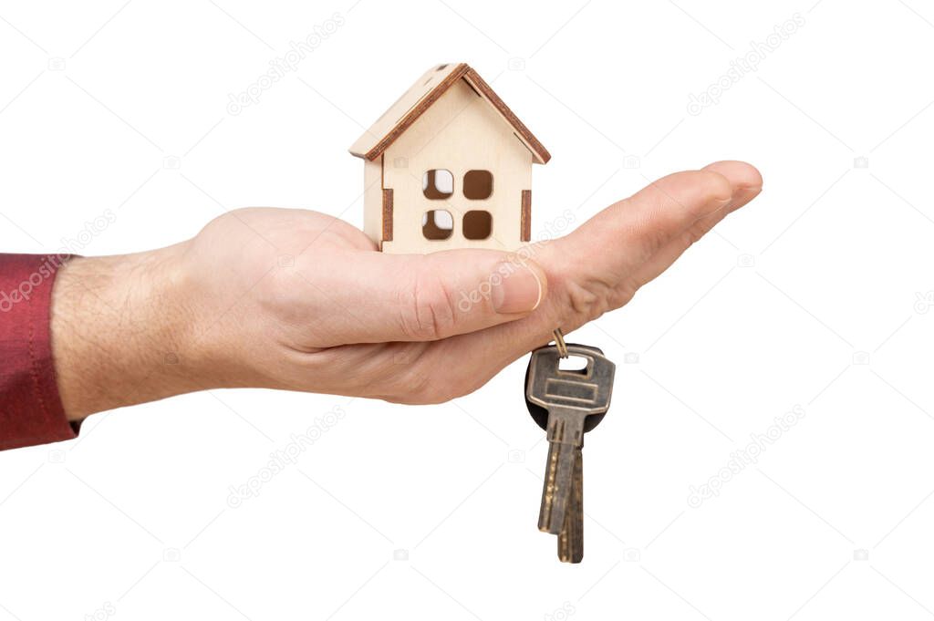 hand holding model house and keys. Close-up of hand holding keys and wooden house model isolated on white background. Mortgage loan approval home loan and insurance concept.