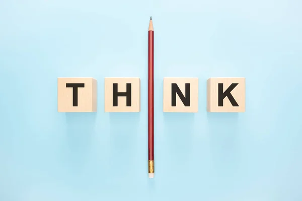 Think concept. Word Think on wooden background. One Pencil with word think. leadership and uniqueness concept. Stand out from the crowd. Dare to be different. blue background