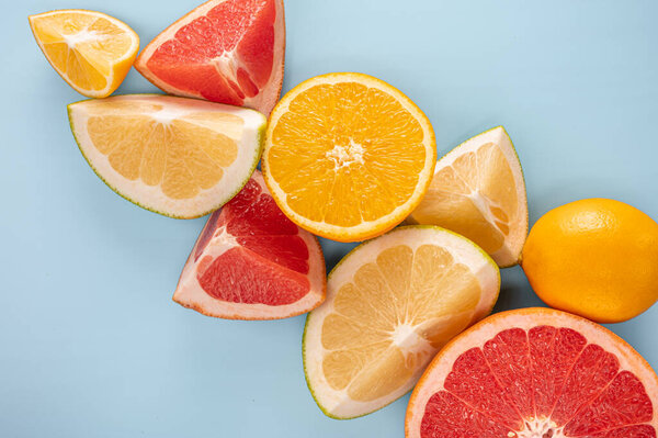 Citrus fruits slice. citrus fruits composition and slice on blue background, Flatlay pattern of citrus orange, lemon, lime and grapefruit slices background. copy space.