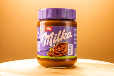 Moscow, USA - APRIL 18, 2021. jar of new milka chocolate paste with hazelnuts on a beautiful background. Milka is a chocolate brand owned by Mondelez International. clipart
