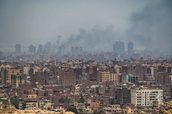 Pollution over Cairo city. smog, smoke, fog, over an Arab city. problem air pollution. aerial view misty city of Cairo in Egypt, due to traffic pollution, over rooftop slums. Aerial View Of Cityscape