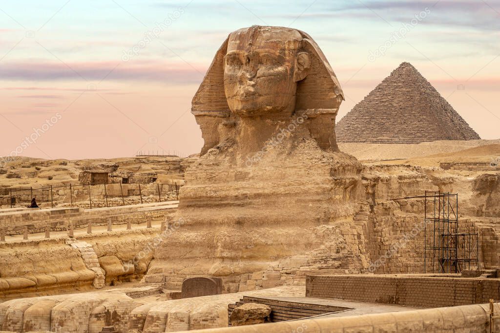 General view of pyramids with Sphinx. The Sphinx in Giza pyramid complex at sunset. incredible view of the face of the Sphinx and the great pyramid. travel background