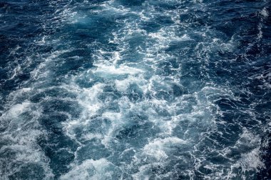 sea water wake, dark blue sea and white foam. sea water wake, dark blue and white foam. Blue sea water texture