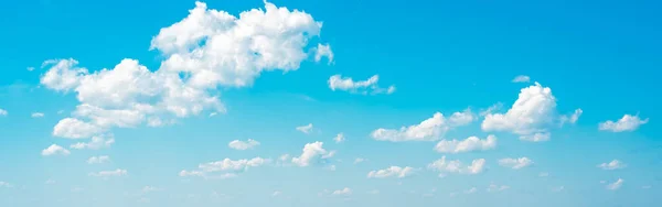 amazing cloud formations on a bright blue sky. beautiful side lit cloudscape panorama in springtime. many white clouds in summer blue sky. Cloudscape horizontal banner