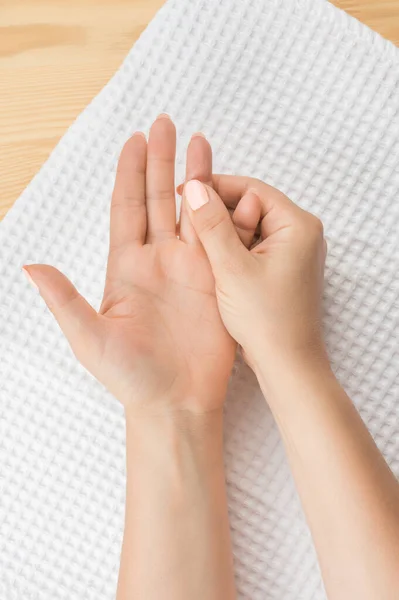 Self hand massage. Healthy Hand Massage. Closeup hand of person massage her hand from pain in healthy concept on white background. accupressure self-massage. vertical, top view