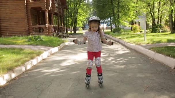 Niña aprende a patinar en el parque — Vídeos de Stock