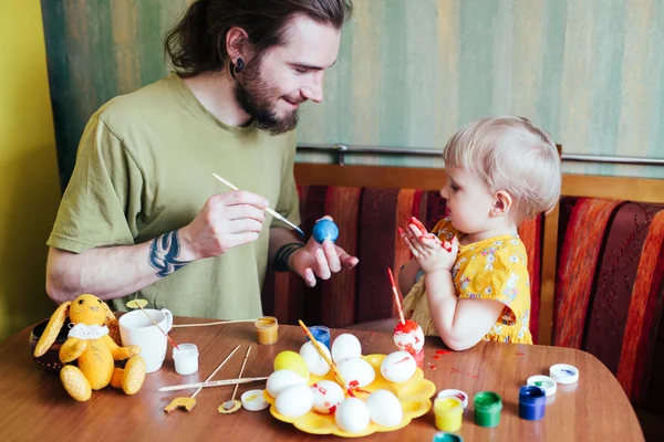 Батько і його дочка малюють великодні яйця . Стокова Картинка