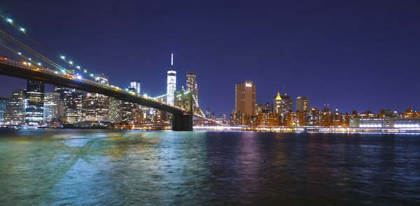 Brooklyn Bridge New York at night and Manhattan skyline