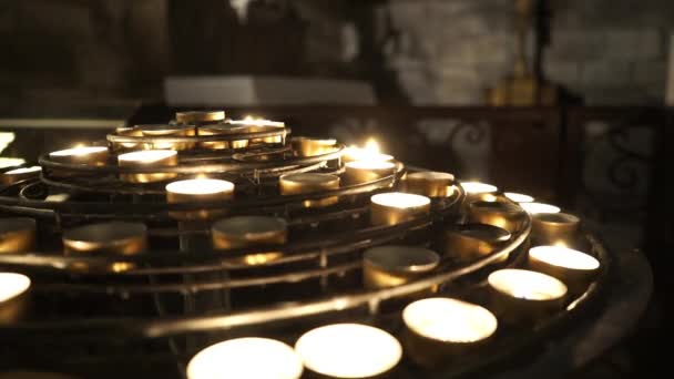 Small tea light candles in a church - PARIS, FRANCE — Stock Video