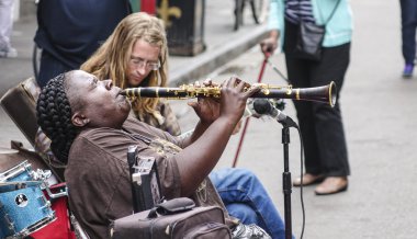 Typical street musicians for jazz music in New Orleans - NEW ORLEANS, LOUSIANA - APRIL 17, 2016 clipart