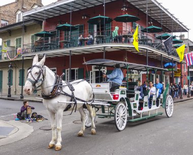 Horse-drawn cab at French Quarter New Orleans - NEW ORLEANS, LOUISIANA - APRIL 18, 2016 clipart