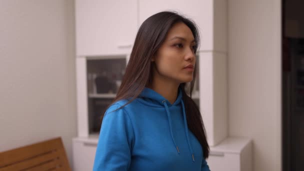 Asian woman sneezes into her elbow during corona — Stock Footage Asian woman sneezes into her elbow during corona Video Clip