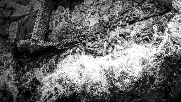 Wild Ocean water from above - Waves hitting the rocks