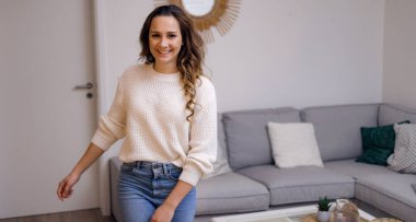 Oturma odasında güzel bir kadın var.