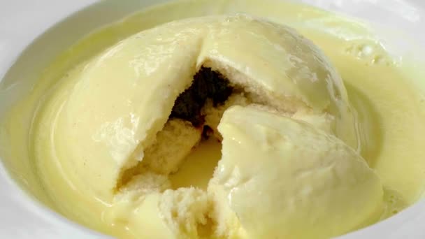 Typical German and Austrian dessert called Germknodel with vanilla sauce — Stock Video