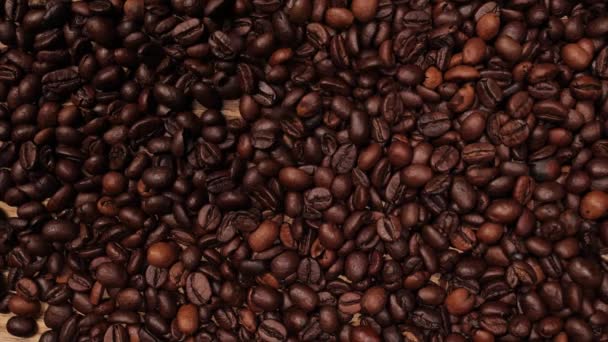 It rains freshly roasted coffee beans in slow motion — Stock Video