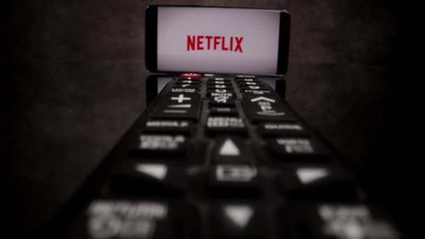 Netflix Streaming - Flight over TV Remote control - CITY OF FRANKFURT, GERMANY - MARCH 29, 2021 — Stock Video