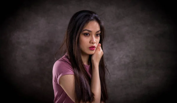 Pretty Asian woman - portrait shot against grey background — Stock Photo, Image