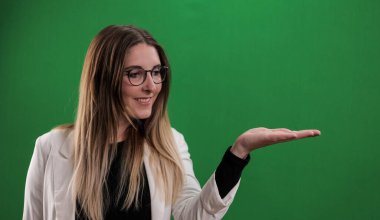 Genç bir kadın avucunda bir şey sunar.